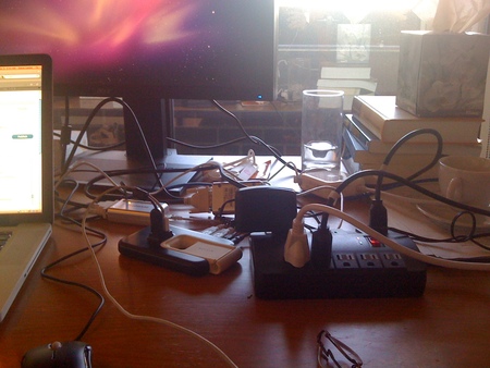 Messy desk, lots of cables