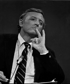 William F. Buckley, chin held way up, looking thoughtful with his hands near his chin in some sort of weird 'wait, how did your hand end up in that position?' kind of posture